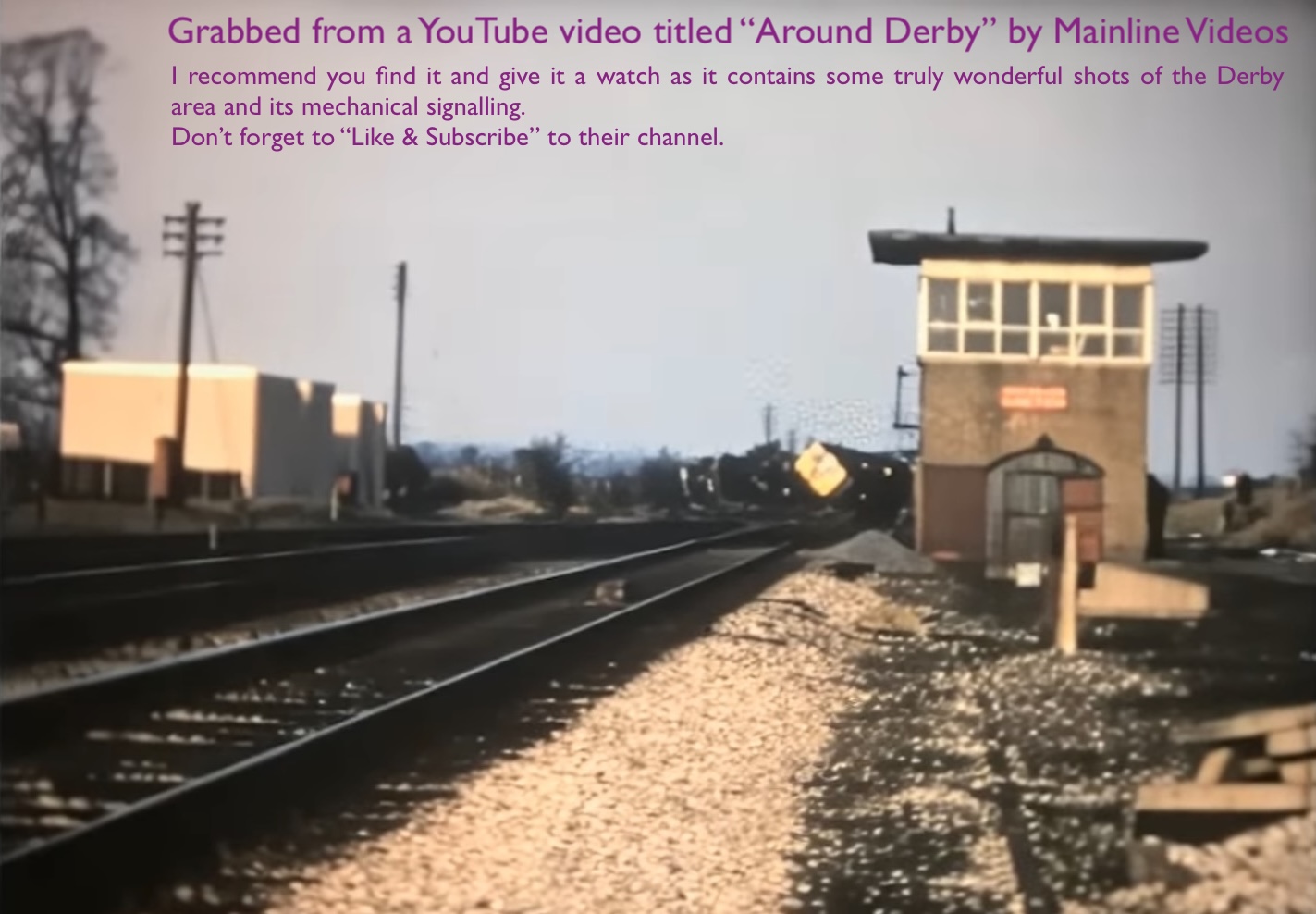 A screen grab of a colour video showing a Diesel Multiple Unit train lying on its side in the distance with Wichnor Junction sifgnal box to the right